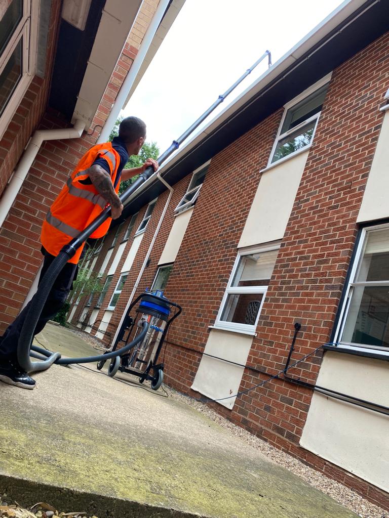 cleaning a building with our gutter cleaning equipment